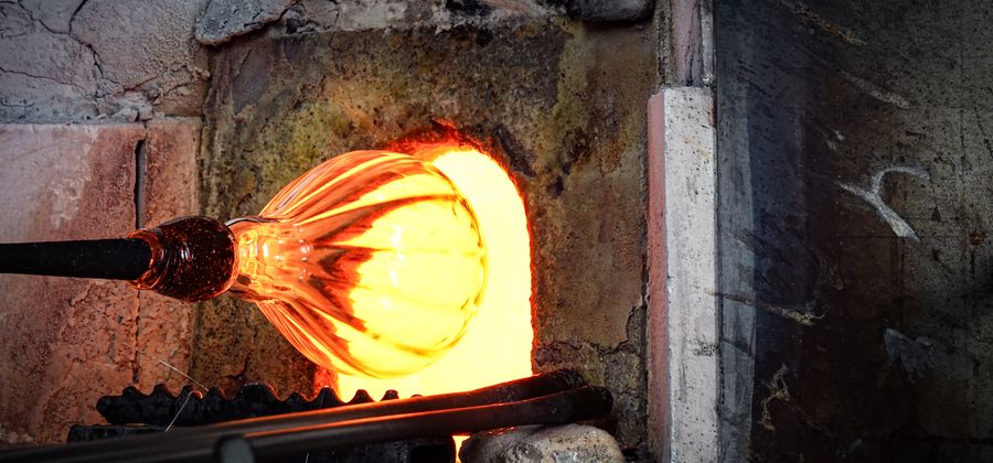 Glowing interior of an industrial firebox showing the refractory lining condition that a boiler inspection documents