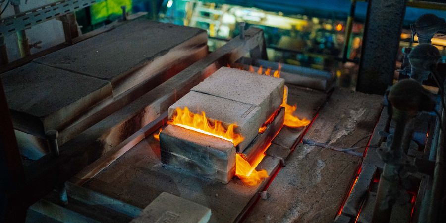 Active glassmaking furnace interior in a factory — insulating backup layers are critical to efficient operation of glass melting furnaces