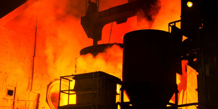 Molten metal casting in an active steel mill — a hot face with molten contact and abrasion that rules out ceramic fiber and demands refractory brick